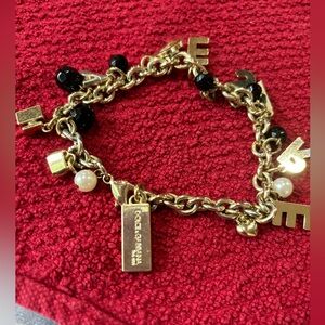 Dolce and Gabbana DESIRE charm bracelet. EUC tones of black gold and pearl.